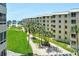 Charming beachfront complex with beautiful lawns, swaying palms, and community bike racks at 5920 Midnight Pass Rd # 406, Sarasota, FL 34242
