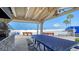 Beach view from covered grill area with stone surround, stainless steel grills, and picnic tables at 5920 Midnight Pass Rd # 406, Sarasota, FL 34242