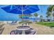 Exterior view of lounge seating and picnic tables near the beach at 5920 Midnight Pass Rd # 406, Sarasota, FL 34242
