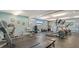 Bright gym featuring various exercise equipment, including elliptical machines and free weights at 5920 Midnight Pass Rd # 406, Sarasota, FL 34242