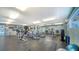 Well-lit gym with treadmills, elliptical machines, weight benches, and a selection of free weights for residents at 5920 Midnight Pass Rd # 406, Sarasota, FL 34242