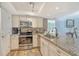 Updated kitchen boasts stainless appliances, granite counters and tiled backsplash at 5920 Midnight Pass Rd # 406, Sarasota, FL 34242