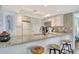 Kitchen featuring granite countertops, stylish backsplash, and modern appliances at 5920 Midnight Pass Rd # 406, Sarasota, FL 34242