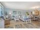 Relaxing living room with ample seating, coastal decor, and a dining area beyond at 5920 Midnight Pass Rd # 406, Sarasota, FL 34242