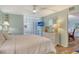 Well-lit bedroom features a large bed, dresser, and decorative glass block window at 5920 Midnight Pass Rd # 406, Sarasota, FL 34242