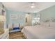 Bright bedroom with a full bed, a sitting nook, and decorative wall art at 5920 Midnight Pass Rd # 406, Sarasota, FL 34242