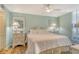 Airy main bedroom features light blue walls, a ceiling fan and white accents at 5920 Midnight Pass Rd # 406, Sarasota, FL 34242