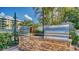 Outdoor grills set in stone counter near pool and tropical landscaping at 5920 Midnight Pass Rd # 406, Sarasota, FL 34242