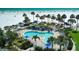 Aerial view of community pool, lounge chairs, umbrellas and white sand beach at 5920 Midnight Pass Rd # 406, Sarasota, FL 34242