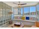Cozy sun room featuring window seating, glass block wall, and a round wooden table at 5920 Midnight Pass Rd # 406, Sarasota, FL 34242