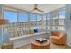 Inviting sun room with built-in seating, ample windows, and a cozy chair perfect for relaxation at 5920 Midnight Pass Rd # 406, Sarasota, FL 34242