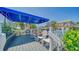 Charming outdoor deck featuring white chairs and a canopy overlooking a lush landscape at 5920 Midnight Pass Rd # 406, Sarasota, FL 34242