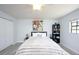A relaxing bedroom with a fluffy white bedspread and a contemporary decor at 6100 Gulfport S Blvd # 117, Gulfport, FL 33707