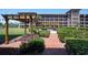 Beautiful condo complex courtyard with manicured landscaping, pergolas and a brick walkway at 6100 Gulfport S Blvd # 117, Gulfport, FL 33707