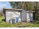 Exterior view of outbuilding with multiple trash cans in front of it at 611 29Th E St, Bradenton, FL 34208