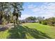 Spacious backyard with lush green grass and mature trees creating a private oasis at 611 29Th E St, Bradenton, FL 34208