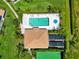 Aerial view of a home with a private pool, solar panels and tennis court at 6339 Bay Cedar Ln # 102, Bradenton, FL 34203