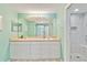 Bathroom featuring double sink vanity and tiled walk-in shower with glass door at 6339 Bay Cedar Ln # 102, Bradenton, FL 34203