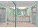 Spacious bathroom featuring dual sinks, a large mirror, and glass-enclosed showers, offering a spa-like experience at 6339 Bay Cedar Ln # 102, Bradenton, FL 34203