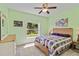 Cozy bedroom with light green walls, comfy bed, and a window offering a view at 6339 Bay Cedar Ln # 102, Bradenton, FL 34203