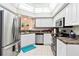 Contemporary kitchen featuring stainless steel appliances, sleek countertops, and a convenient dishwasher for easy cleanup at 6339 Bay Cedar Ln # 102, Bradenton, FL 34203