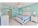 Serene main bedroom featuring a comfortable bed, soft blue walls, and an inviting ensuite bathroom entrance at 6339 Bay Cedar Ln # 102, Bradenton, FL 34203