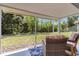 Relaxing screened in patio with nice furniture and view of grassy backyard at 6339 Bay Cedar Ln # 102, Bradenton, FL 34203