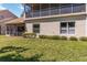 Exterior view of the back of the home with a screened-in porch, and a lush green lawn at 6339 Bay Cedar Ln # 102, Bradenton, FL 34203