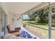 Relaxing screened patio with comfortable seating, a blue rug, and beautiful views of the manicured backyard at 6339 Bay Cedar Ln # 102, Bradenton, FL 34203