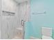 Walk-in shower with stylish glass door, white marble tiling, and decorative niche at 6339 Bay Cedar Ln # 102, Bradenton, FL 34203