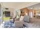 Inviting sunroom featuring comfortable seating, a blue rug, and an open doorway at 6339 Bay Cedar Ln # 102, Bradenton, FL 34203