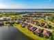 Aerial view of home in a waterfront community with lake and golf course views at 6524 Willowshire Way, Bradenton, FL 34212