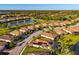 Aerial view showcases a neighborhood with waterfront homes, lush landscaping, and tile roofs under clear skies at 6524 Willowshire Way, Bradenton, FL 34212