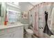 Charming bathroom with elegant shower curtain, vanity and decorative wall art at 6524 Willowshire Way, Bradenton, FL 34212