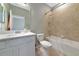Neat bathroom showcasing a shower-tub, a white vanity, and a large mirror at 6524 Willowshire Way, Bradenton, FL 34212