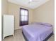 Cozy bedroom with a window, ceiling fan, and light-colored laminate floors at 6524 Willowshire Way, Bradenton, FL 34212