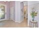 Open foyer with tile flooring, decorative lighting, and view to the bathroom at 6524 Willowshire Way, Bradenton, FL 34212