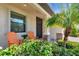 Inviting front entrance with a lush garden, seating, a decorative door and stone pillar accents at 6524 Willowshire Way, Bradenton, FL 34212