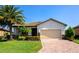 Beautiful single-story home with a brick driveway, well-manicured lawn and mature landscaping with a two car garage at 6524 Willowshire Way, Bradenton, FL 34212