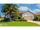 Well-maintained front exterior with lush greenery, brick-paved driveway, and an attached two-car garage at 6524 Willowshire Way, Bradenton, FL 34212