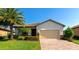 Beautiful single-story home with lush landscaping, brick driveway, and a two-car garage at 6524 Willowshire Way, Bradenton, FL 34212