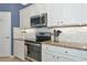 This modern kitchen features sleek stainless steel appliances, granite countertops, and subway tile backsplash at 6524 Willowshire Way, Bradenton, FL 34212