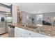 Open-concept kitchen with granite countertops, stainless steel dishwasher, and view into the living room at 6524 Willowshire Way, Bradenton, FL 34212