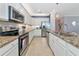 Spacious kitchen featuring stainless steel appliances, granite countertops, and ample cabinet space at 6524 Willowshire Way, Bradenton, FL 34212