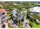 An aerial view of a two-story home with mature tropical landscaping and a circular driveway at 7118 Hawks Harbor Cir, Bradenton, FL 34207