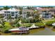 Aerial view of this waterfront property with lush landscaping, a boat dock, and sparkling pool at 7118 Hawks Harbor Cir, Bradenton, FL 34207