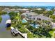 An aerial view of a waterfront property with a pool, dock, and lush landscaping at 7118 Hawks Harbor Cir, Bradenton, FL 34207