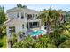 A stunning backyard with a beautiful swimming pool, tropical landscaping, and outdoor seating at 7118 Hawks Harbor Cir, Bradenton, FL 34207
