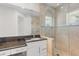 Stylish bathroom features a glass-enclosed shower and vanity with granite countertop at 7118 Hawks Harbor Cir, Bradenton, FL 34207