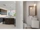 Modern bathroom and kitchen view showcases a stylish sink and adjacent kitchen with dark cabinetry at 7118 Hawks Harbor Cir, Bradenton, FL 34207